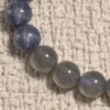Close-up of blue kyanite and smoky grey moonstone beads in the Dusk Meridian bracelet
