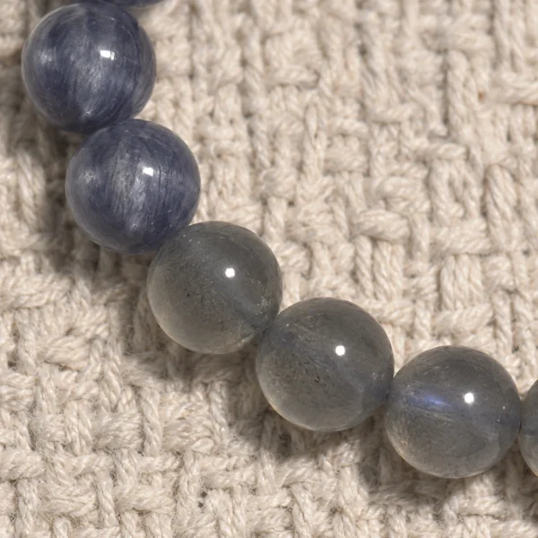 Close-up of blue kyanite and smoky grey moonstone beads in the Dusk Meridian bracelet