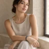 Model wearing the Dusk Meridian blue and grey bracelet beside a stone window