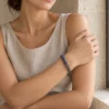 Dusk Meridian kyanite and grey moonstone bracelet worn with a neutral sleeveless dress