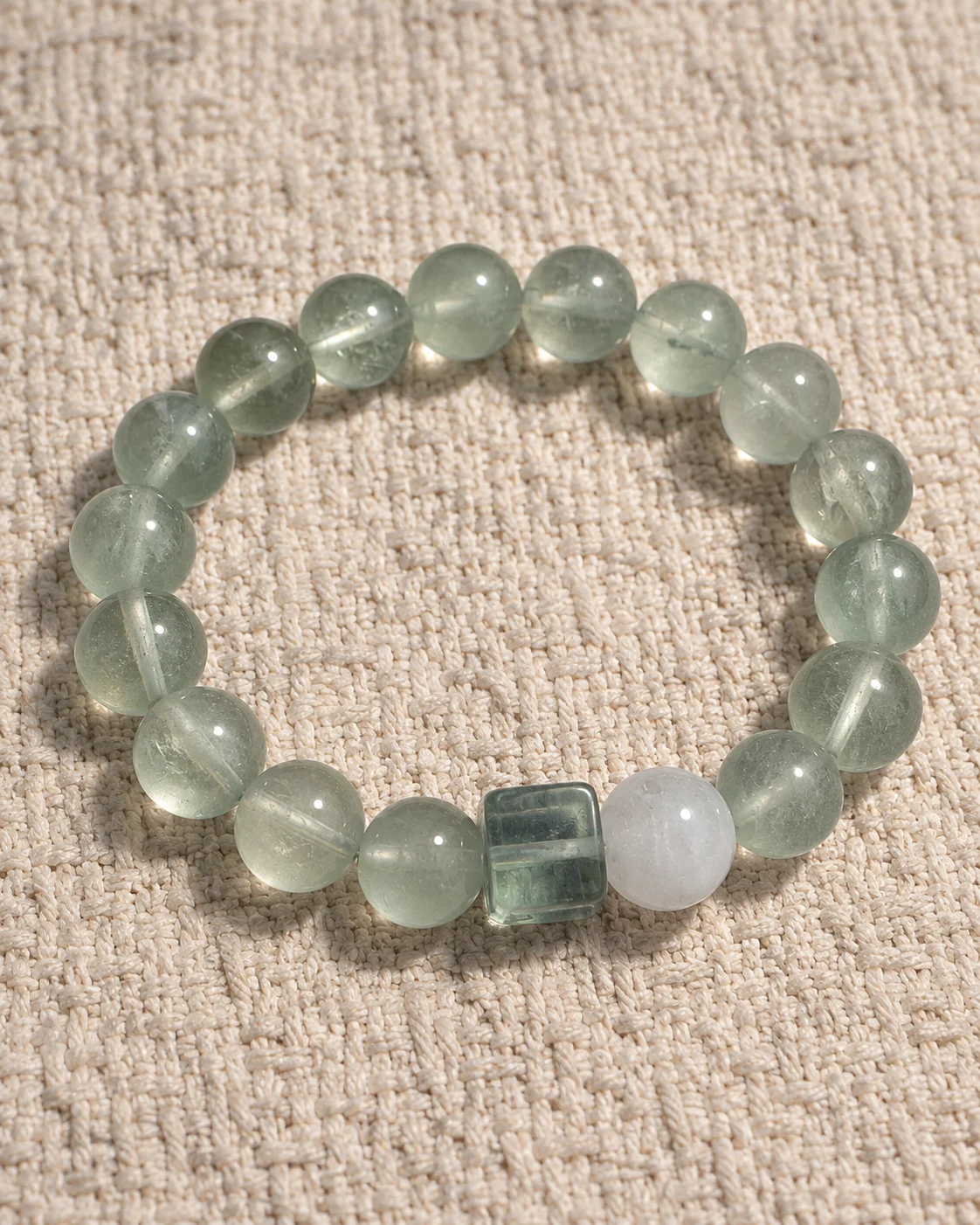 Tidal Glass green fluorite bracelet with a square fluorite accent and white phantom quartz bead on linen
